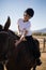 Rider girl caressing the horse in the ranch