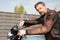Rider man in brown leather motorbike fashion jacket on vintage retro motorcycle