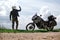 Rider Man holds a smartphone, lost the signal, coverage of mobile communication, off road adventure motorcycles with side bags and