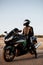 Rider on a motorbike driving at sunset - space for your text biker and motorbike ready to ride
