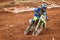 Rider Negotiates Turn At Muddy Motocross Race