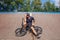 Rider sitting on BMX in skate park resting after riding