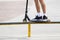 rider on stunt kick scooter slides along edge of metal ramp in skate park