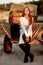 Rider woman in helmet stands near stables