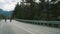 Riders cycling mountain landscape in summer forest. Friends ride bikes on road