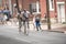 Riders racing on their penny-farthing bicycle downtown