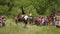 Riders riding on horses, they show acrobatics