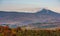 Ridge with high peak above hills with forest