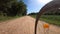 Riding a bicycle on a countryside path front wheel point of view