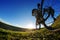 Riding a bike down a trail, close-up the rear wheel. Showing of the workings of the bike. Shallow depth of field.