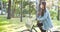 Riding a bike in park, cycling during quarantine. Girl in mask drives bicycle.
