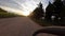 Riding a bike on a rural path on a sunrise landscape on green rice countryside fields