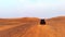 Riding buggies in the desert during sunset