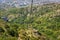 Riding the Chair Lift through the Forest of `The Old Mountan` on Balkan peninsula. Trees on the Hills surrounding in the Mountains