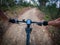 Riding a dark mountain bike rider point of view with a navigator on handlebar on a gravel sand road