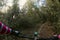 Riding a mountain bike handle bar point of view while chasing other riders on narrow single track in the middle of a green forest