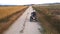 Riding quad bike. Man in protective equipment and helmet, drifting on his ATV at sunset. Aerial footage.