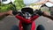 Riding a red rental bike on the roads of Phuket