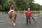 Riding school pupil and instructor