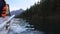 Riding a Speedboat On The Mountain River With Thick Wood On The Shore View From Boat Side