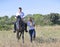 Riding teenager, teacher and horse