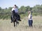 Riding teenager, teacher and horse