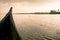 Riding wood fishing boat in kerala vembanad lake at sunrise a pristine natural environment during monsoon season, symbol of rural