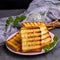 Ried square pieces of white bread on a pink ceramic plate