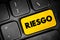 Riesgo (spanish words for Risk) text button on keyboard, concept background