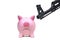 A rifle pointing at a pink piggy bank