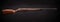 Rifle with a wooden stock on a dark back. Weapons for sports, hunting and self-defense