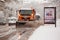 RIGA, LATVIA - 2016 NOVEMBER 4: Snow cleaner car cleans snowy road and shedds salt