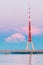 Riga, Latvia. Famous Landmark Television Tower In Pink Purple Sunset Or Sunrise Colors Sky.