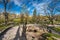 RIGA, LATVIA - MAY 06, 2017: View on pathways with blossom trees, bushes and walking people in The Park Bastion Hi