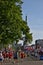 Riga, Latvia - May 19 2019: Marathon runners reaching freedom statue with traditionally clothed cheerleaders are giving high fives