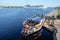 Riga, Latvia - May 21, 2016: Cruise Ship MSC Opera turning round and Touristic river boat with paddle wheel by the city