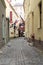 Riga, Latvia, November 2019. Old narrow street, signboards of hotels and multi-colored flags.