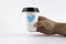 RIGA, LATVIA - October 19, 2015:Paper cup of coffee in hand and twitter sign