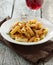 Rigatoni pasta with tomato meat sauce and wine