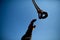 Rigger construction worker hand wearing a heavy duty glove reaching to the sky to catching crane chain block hooks