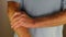 Right Forearm of a Man Being Self Massaged by His Left Hand Close-up