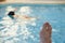 Right male foot in front of a pool with an unidentified person snorkeling