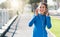 The right music fuels the right mindset. Shot of a sporty young woman listening to music while exercising outdoors.