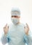 Right positioned hands of ready to work surgeon in sterile gown, mask and gloves