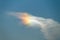 Right side sun, rainbow colors in the ice crystals of a cloud