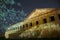 Right wing of count Potocki palace in Tulchyn on a warm spring night against clear dark blue sky full of star tracks, photo