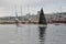 Rijeka, Croatia September 2020. Sailing boat with black open sails in the port of Rijeka.