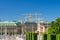Riksplan, bushes and street with national flags on Sodermalm island, Gustav Adolfs torg square, Royal Swedish Opera house building