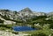 Rila mountains in Bulgaria, deep blue lakes and gray rock summit during the sunny day with clear blue sky