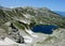 Rila mountains in Bulgaria, deep blue lakes and gray rock summit during the sunny day with clear blue sky